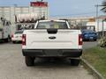 White 2018 Ford F-150 pickup truck viewed from the rear with a visible tailgate and black bumper