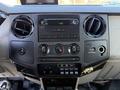 Interior dashboard controls of a 2009 Ford F-550 featuring audio system climate control switches and various buttons for vehicle functions