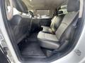 Interior view of a 2012 RAM 2500's rear seating area featuring black and gray upholstery with two seats and a floor mat