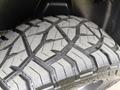 Close-up of a rugged tire from a 2018 RAM 1500 showcasing its deep tread pattern designed for off-road traction