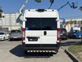 A 2020 RAM ProMaster 3500 van viewed from the rear with a wheelchair accessibility symbol on the back door