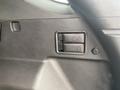 Close-up of the interior door panel of a 2022 Chevrolet Equinox featuring window controls and a lock button
