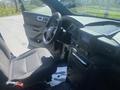 Interior of a 2020 Ford Explorer with a driver's seat black fabric upholstery and a dashboard featuring controls and a screen