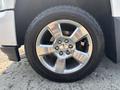 A close-up of a shiny wheel on a 2017 Chevrolet Silverado 1500 showing five spokes and a General tire
