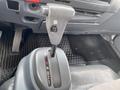 The image shows the gear shift lever of a 2019 Isuzu NRR with markings for park reverse neutral and drive settings