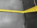A measuring tape lying on a flat surface showing measurements in inches and centimeters