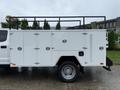 A 2020 Ford F-550 with a white utility box attached to the truck bed featuring multiple compartments and access doors
