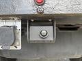 A close-up of a black towing hitch on a 2021 RAM 5500 with an electrical connector next to it