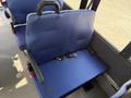 Blue upholstered seat in a 2020 Chevrolet Express with seat belts attached