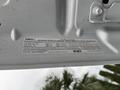 A 2016 Ford F-550 Super Duty with an engine information label attached to the underside of the hood