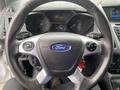 Steering wheel of a 2017 Ford Transit Connect featuring the Ford logo and various control buttons on its spokes