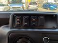 Dashboard panel of a 2013 Ford Econoline showing four switches labeled for door operation lights and step heater