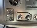 Air conditioning control panel of a 2012 Ford Econoline E-450 featuring knobs for front and rear airflow settings and temperature adjustment