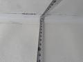 A measuring tape extended along a ceiling or wall surface showing various measurements