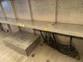 Interior view of a 2012 Ford Econoline with metal shelving and a storage area featuring straps for securing cargo
