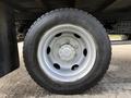 A silver wheel with a six-bolt pattern and black tire labeled S740 designed for a 2014 Hino 195 truck