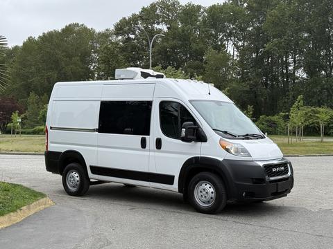 2020 RAM Promaster van with a white exterior and a high roof featuring a rooftop unit parked with a black grille and wheels