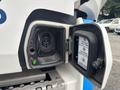 A close-up view of the charging port on a 2020 Lion Lion6 electric vehicle displaying a power connector and indicator lights