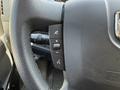 Steering wheel of a 2021 RAM Promaster featuring controls for audio system and cruise control