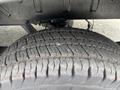 A close-up of a worn tire from a 2020 Ford Transit 250 showing detailed tread patterns and slight wear on the rubber surface