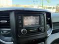 A close-up of the dashboard of a 2020 Ram 2500 featuring a touch screen radio display with various control buttons and a digital clock
