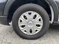 A close-up of a 2020 Ford Transit 250 wheel featuring a silver metal hubcap and black tire with visible tread pattern