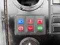Control panel of a 2004 Bombardier SW48 featuring five colored buttons in blue red and green for various functions including lights battery and water levels