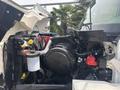 A 2012 International 7300 Workstar truck with its hood opened revealing the engine compartment including various components and hoses