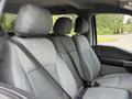 Interior view of a 2021 Ford F-150 showing three seats with gray fabric upholstery and seatbelts fastened