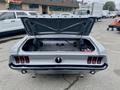 A 1968 Ford Mustang Two Door Convertible with its trunk open showing a clean interior and visible battery compartment