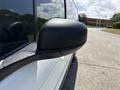 Close-up of the side mirror of a 2021 Ford Transit Connect with water droplets on its surface