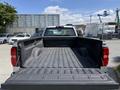 A 2016 Chevrolet Silverado 2500HD with an empty truck bed viewed from the rear
