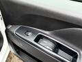 Interior door panel of a 2017 RAM ProMaster City featuring a window control button and a storage compartment
