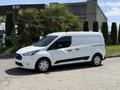 A white 2021 Ford Transit Connect van with sliding doors and a standard wheelbase parked on a street