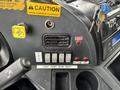 Interior dashboard controls of a 2017 Autocar Xpert featuring various buttons and switches for operation and a warning label indicating caution
