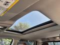 Sunroof of a 2015 RAM 1500 with a clear view of the sky through the glass panel and surrounding headliner