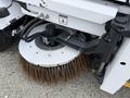 A 2012 Global M4 street sweeper with a large circular broom attachment featuring long bristles for cleaning surfaces