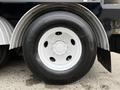 A close-up of a white wheel with a black tire on a 2013 International Workstar 7500 truck