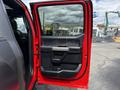 A 2019 Ford F-150 truck door is open revealing the interior door panel and handle design with a black and gray color scheme