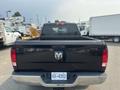 A black 2015 RAM 1500 pickup truck viewed from the rear showing the tailgate and rear lights with a visible license plate