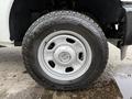 A close-up of the wheel and tire of a 2015 Ford F-350 SD featuring a silver alloy rim and a Sumitomo all-terrain tire