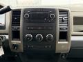 The dashboard of a 2012 Dodge Ram 5500 featuring a radio controls air conditioning knobs and various function buttons