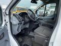 Interior view of a 2017 Ford Transit showing front seats dashboard and steering wheel