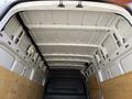 The interior cargo area of a 2022 Mercedes-Benz Sprinter van featuring a high roof and wooden paneling on the sides