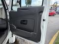 The image shows the open driver's side door of a 2014 International TerraStar featuring a black interior panel with a door handle and storage compartment
