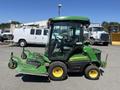 A 2016 John Deere 1585 Terrain Cut mower with a green and yellow design featuring a cab and a front-mounted mowing deck