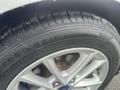 Close-up of a tire on a 2018 Ford Focus featuring a silver wheel rim and detailed tread pattern