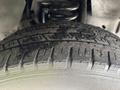 A close-up view of the tire of a 2012 Ford E-450 Super Duty showcasing tread patterns and surface details