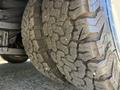 Close-up of a heavy-duty tire with deep treads and rugged texture on a 2013 Chevrolet Express