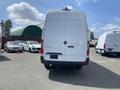 A 2024 Mercedes-Benz Sprinter van with a white exterior is parked with its rear view facing the camera